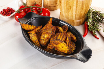 Golden baked potato Idaho with spices
