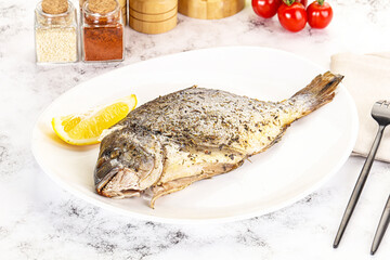 Baked Dorado fish served lemon