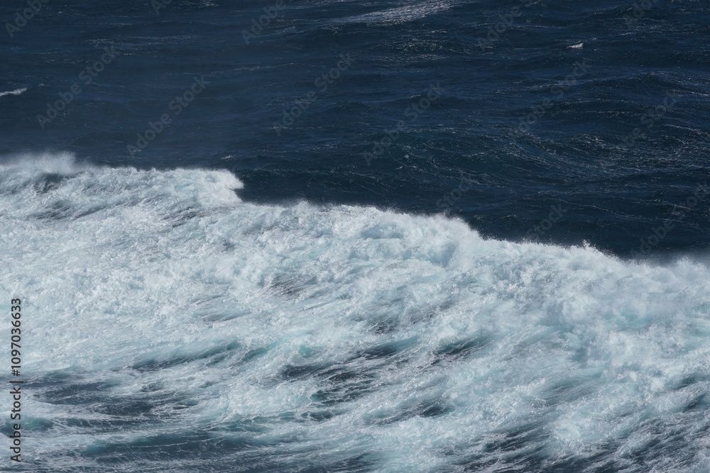Aufkleber waves crashing on deep blue ocean create dynamic and powerful scene. contrast between white foam and