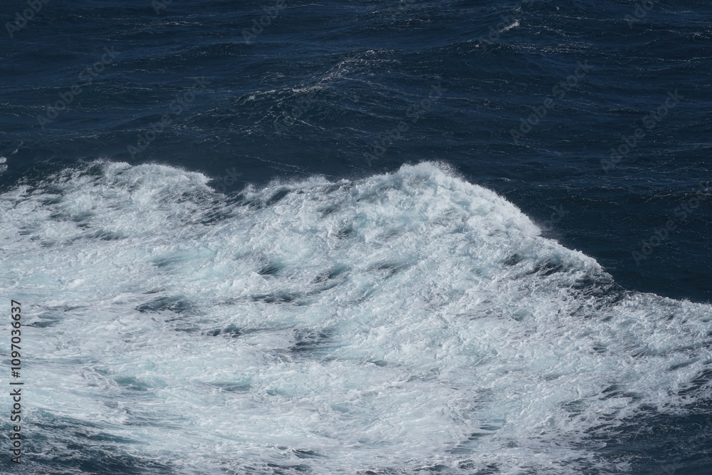 Poster waves crashing on deep blue ocean surface create dynamic and powerful scene. foamy white crest contr