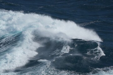 Powerful ocean waves crashing against shore create dramatic scene of nature force and beauty