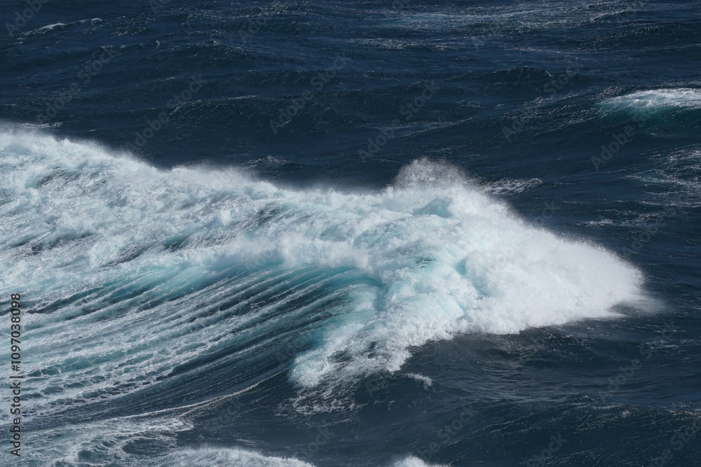 Poster majestic ocean waves crashing against each other, creating dynamic and powerful scene. deep blue wat