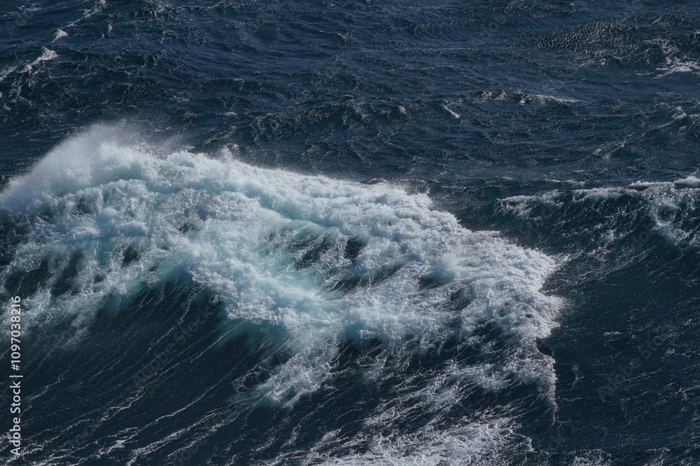 Poster waves crashing on dark ocean surface, creating dynamic and powerful scene. contrast of white foam ag