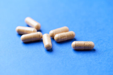 Korean Ginseng capsules. Concept for a healthy dietary supplementation. Bright paper background. Close up.	