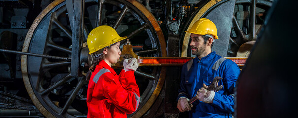 Engineer checking construction process railway and checking work on railroad station . Railway engineer checking machines in train station. Train engineer concept