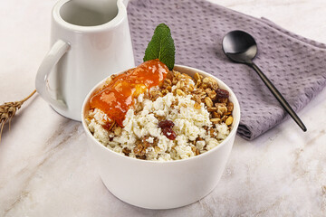 Curd with granola and orange jam