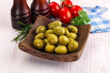 Green marinated olives in the bowl