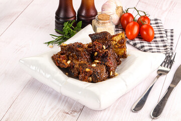 Prepared tasty beef ribs with sauce