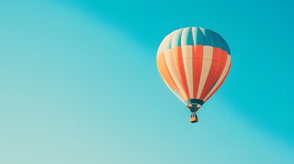 Fototapeta premium A colorful hot air balloon floating in a clear blue sky