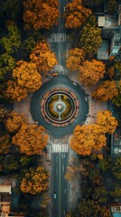 Aerial view of a circular fountain surrounded by vibrant autumn trees and urban streets.