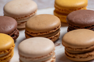 Sweet Colorful Macrons, Light cream french pastas, light background with soft shadows, sweet pastas, french  cookies in beige and brown