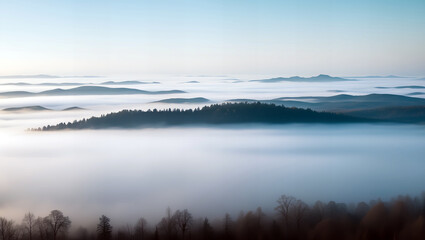 Obraz premium Serene mountain landscape featuring mist-covered valleys, snow-capped peaks, and dense evergreen forests under a soft, cloudy sky.
