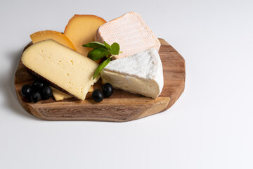 Variety of cheese: camembert, gouda, brie with nuts, parmesan, goat, sheep and other hard cheeses