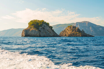 The photo of the stunning Amalfi Coast from a cruise ship deck, showcasing cliffs, charming villages, and lush landscapes against the turquoise sea and vibrant blue sky. Positano, Amalfi, Atrani