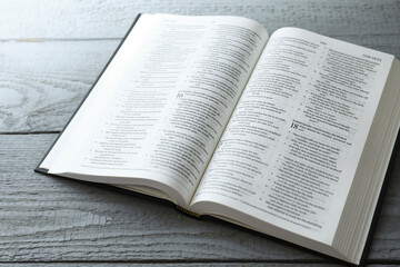 Open Holy Bible in English language on wooden table