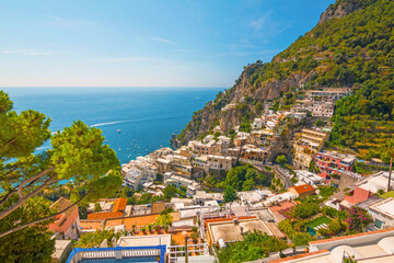 The photo captures a view of Positano, with its colorful, stacked houses cascading down the cliffs,...