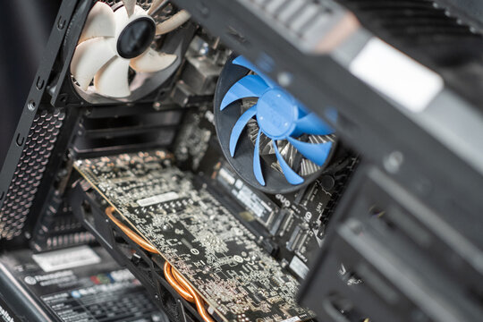 Inside a modern computer showcasing a cooling system, graphics card, and intricate hardware components in a tech workspace
