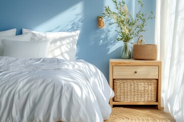 Bright and airy bedroom with sky blue walls, white bedding, and a natural wood nightstand.