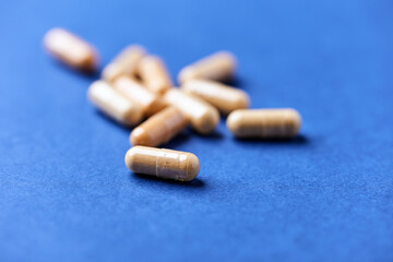 Lutein capsules. Dietary supplement on bright background. Soft focus. Close up. Copy space	