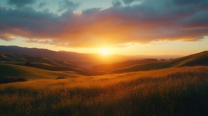 Vibrant sunset over rolling hills and grassy field.