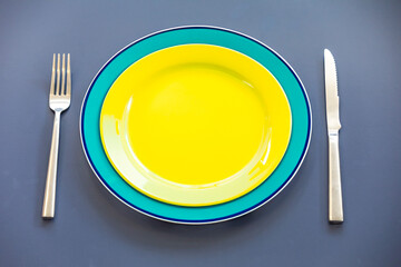 Empty plate top view with metal cutlery next to it