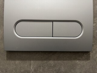 Close up of plastic toilet flush button
