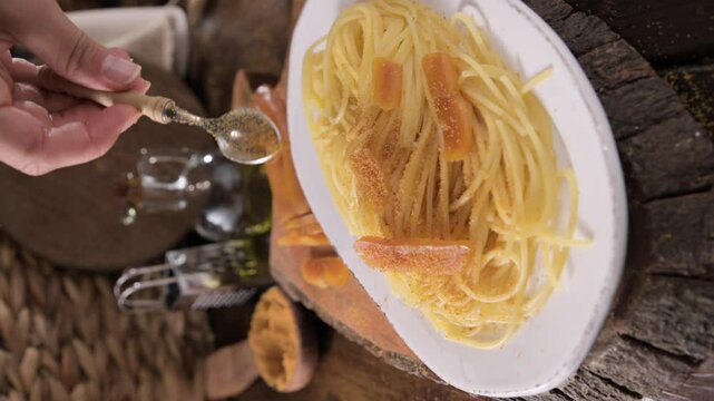 Spaghetti with bottarga. Typical Sardinian Cuisine. A dish with traditional Italian pasta from the South, dried sardine roe, lemon and pasta. High quality 4k footage
