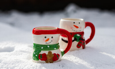 cute snowman shaped tea cups in snow
