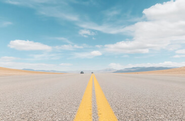 Fototapeta premium A straight highway stretching into the horizon, photographed from ground level, with a lone car in the distance under a dramatic cloudy sky