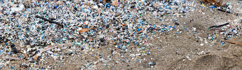 microplastics on the beach, an example of pollution, panorama banner
