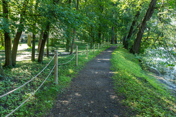 A path in a park with a fence on the side