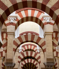 A view of the red and white striped arches inside the Mezquita in Cordoba, Spain