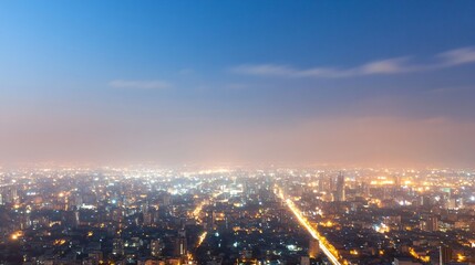 Fototapeta premium Beautiful urban night cityscape with glowing lights and illuminated streets stretching to horizon. Aerial panoramic view of modern metropolis under evening sky. City lights banner with copy space