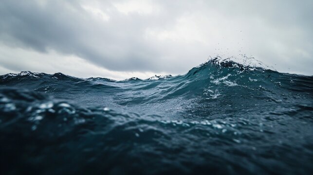 Dark stormy ocean waves under cloudy sky. Dramatic seascape view from water level. Powerful marine nature background for environmental projects and weather concepts with copy space
