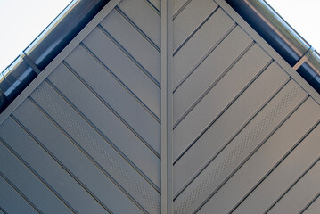 Fototapeta premium Metal soffit and plastic gutters blend modern design with sky views
