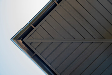 Gray metal soffit on a house with gutter system