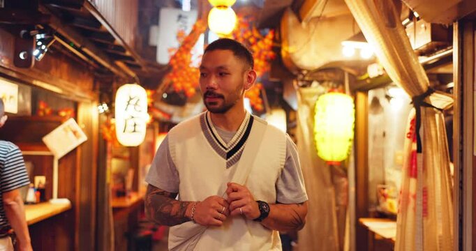 Night, happy man and travel in Japan for street food, journey and tourism in Omoide Yokocho for history. Tourist, walk and traditional kiosks in Tokyo for culture heritage, memory lane and experience