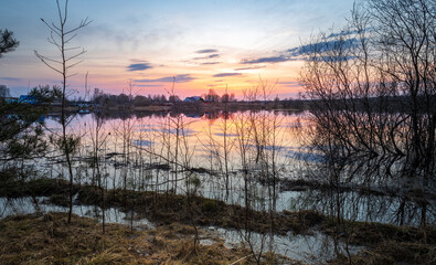 Beautiful sunset over a lake with a house in the background