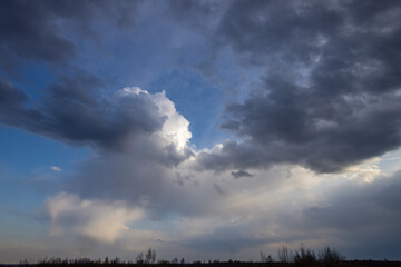 The sky is cloudy and the sun is shining through the clouds