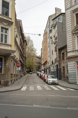 Street with a red car parked on the side of the road