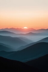 Obraz premium Stunning sunset over misty mountain ranges at twilight hour