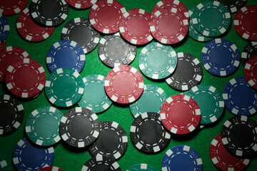Poker chips on green table, flat lay