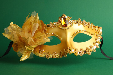 Beautiful golden carnival mask on green background