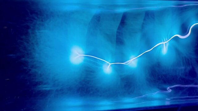 Blue neon gas discharge in plasma in transparent glass tube