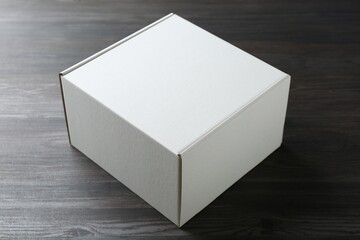 One blank cardboard box on wooden background. Mockup for design