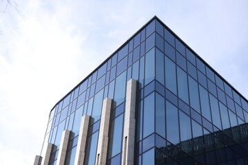 Exterior of modern building with many windows outdoors, low angle view