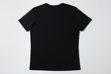 One blank t-shirt on white background, top view. Mockup for design