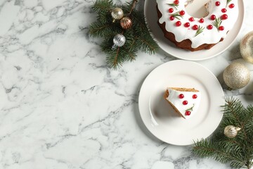 Traditional classic Christmas cake and decor on white marble table, flat lay. Space for text