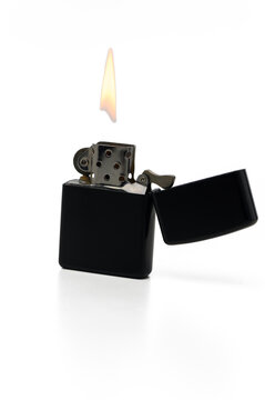 Gaziveren Cyprus -23.11.2024 petrol zippo lighter Classic black lighter ignites with a bright flame amidst a minimalist background
