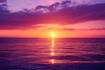 Obraz premium Vivid sunset over calm ocean waters creates a breathtaking seascape